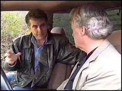 Parker shown discussing a case with John Walsh of America's Most Wanted
